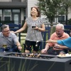 a group of people laughing around a fire